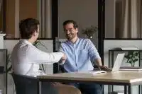 A landlord shaking hands with a business partner demonstrating real estate investor relationships_NREIG