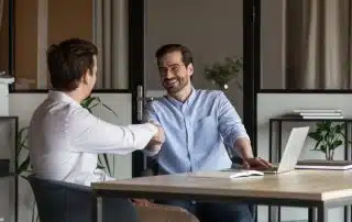 A landlord shaking hands with a business partner demonstrating real estate investor relationships_NREIG