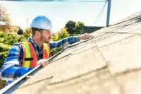 man inspecting roof using a rental property inspection checklist_NREIG