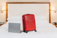 mid-term rental with suitcase and laptop in furnished temporary housing