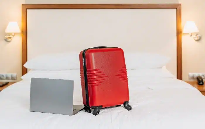 mid-term rental with suitcase and laptop in furnished temporary housing